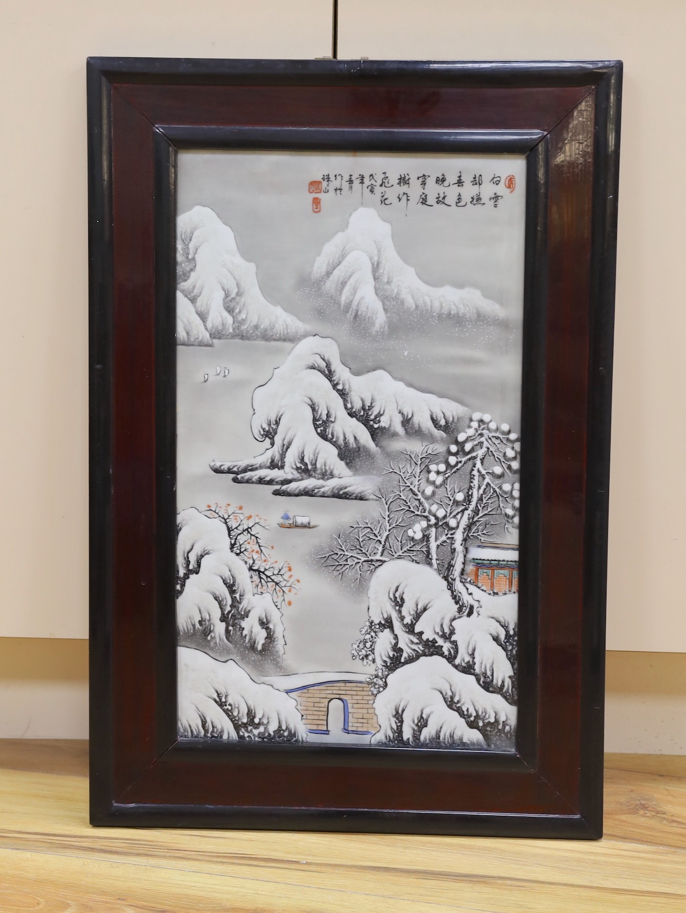 A Chinese framed porcelain plaque decorated with a winter scene, 31 cms wide x 54 cms high (not including frame)